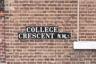 Text on brick wall