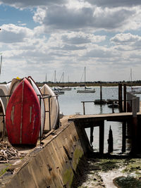 Boats moored in sea against sky