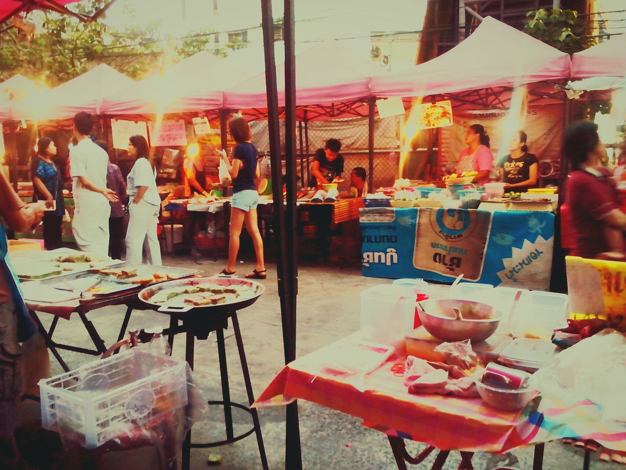 table, restaurant, food and drink, indoors, chair, arrangement, drink, for sale, cafe, retail, variation, incidental people, sidewalk cafe, drinking glass, glass - material, still life, food and drink industry, large group of objects, place setting, market stall