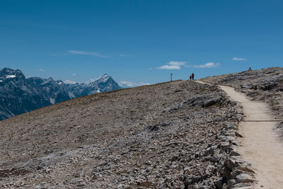 People on mountain against sky