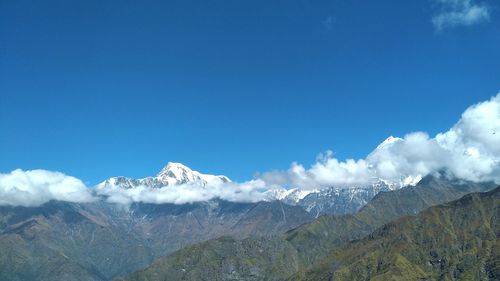 Scenic view of mountains against blue sky