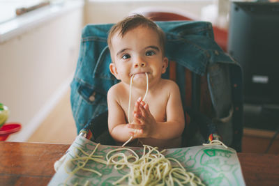 Portrait of cute girl sitting at home