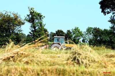 Abandoned truck on field against clear sky