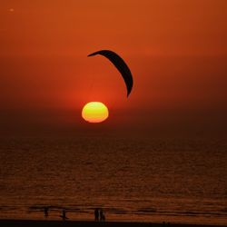 Scenic view of sea against orange sky