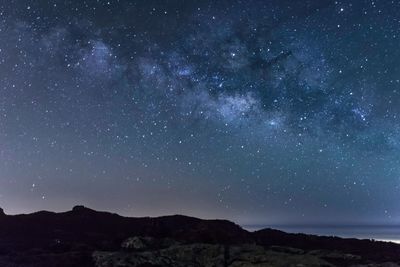 Scenic view of star field against sky at night