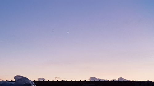 Scenic view of moon against clear sky at sunset