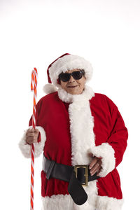 Man wearing sunglasses standing against white background