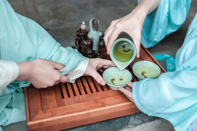 High angle view of people sitting on table