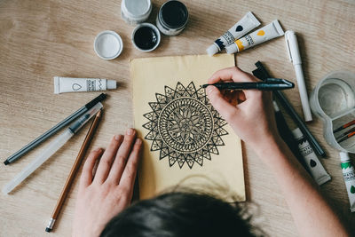 High angle view of person hand on table