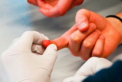 Cropped hands of doctor examining patient