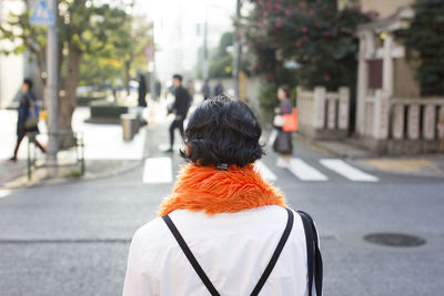 Rear view of woman walking on street