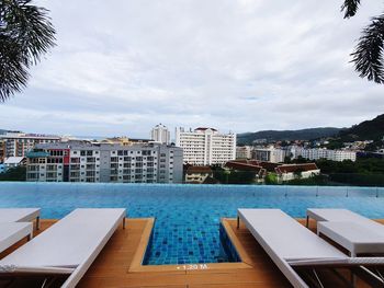 High angle view of swimming pool against buildings in city