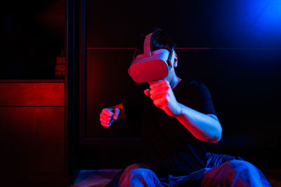 Gamer man wearing virtual reality goggles