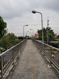 Street by road against sky