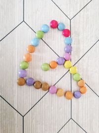 High angle view of multi colored candies on wooden floor