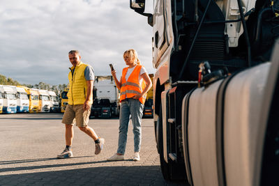 Rear view of couple walking on road