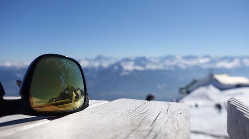 Close-up of snow on mountain against clear blue sky