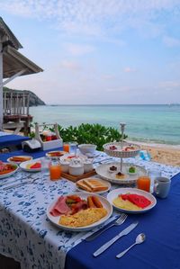 High angle view of food on table at beach against sky