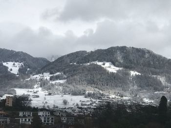 Buildings in city against sky during winter