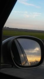 Reflection of car on road at sunset