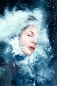 Part of a woman's face covered with water and milk creating the look of a universe