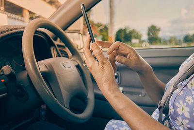 Midsection of man driving car