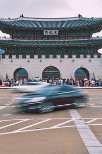 Cars moving on road against gyeongbokgung