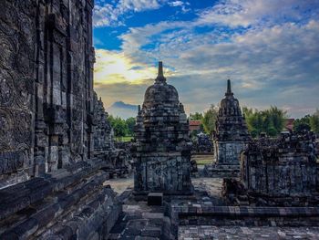 Statue of temple against cloudy sky