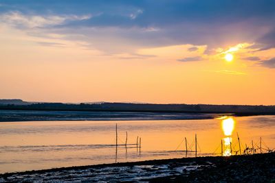 Scenic view of beach against sky during sunset