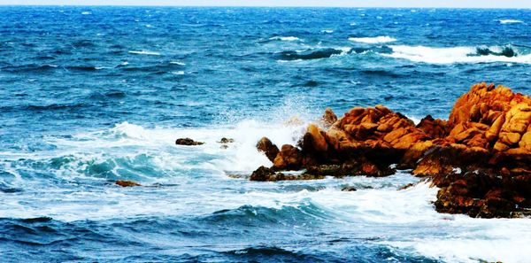 Scenic view of sea against blue sky