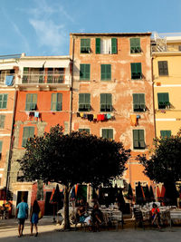 People on street against buildings in city