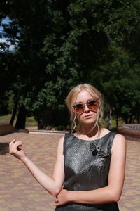 Portrait of woman standing at park