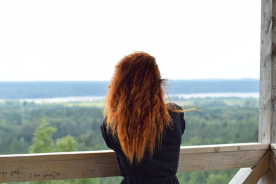 Rear view of woman standing against clear sky