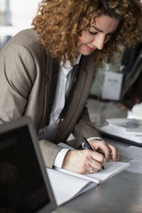 Businesswoman registering for seminar at conference center