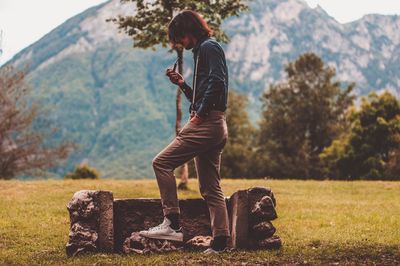 Woman with arms outstretched against mountains