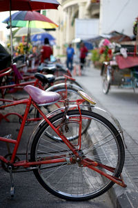 Close-up of bicycle wheel in city