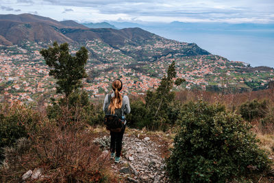 Rear view of man standing on mountain