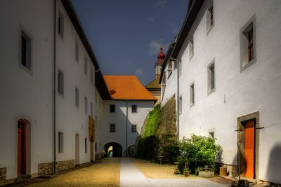 Empty alley amidst buildings in city