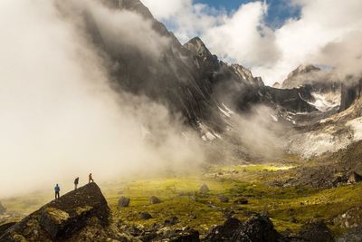 Panoramic view of mountain range against cloudy sky