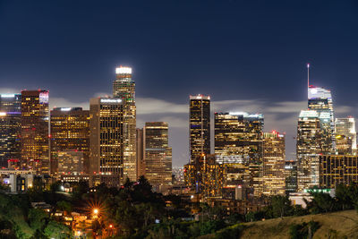 Illuminated buildings in city at night