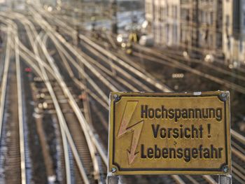 Close-up of information sign on railroad track