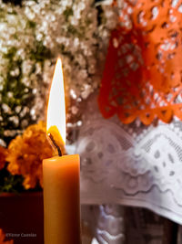 Close-up of lit tea light candles in temple