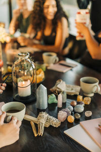 Sage and variety of crystals arranged on dining table at retreat center
