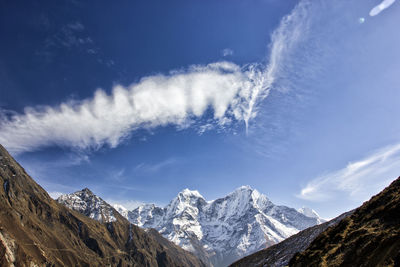 Scenic view of snowcapped mountains against sky