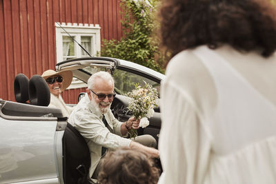 Man leaving convertible car