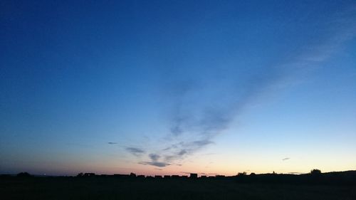 Silhouette landscape against clear blue sky