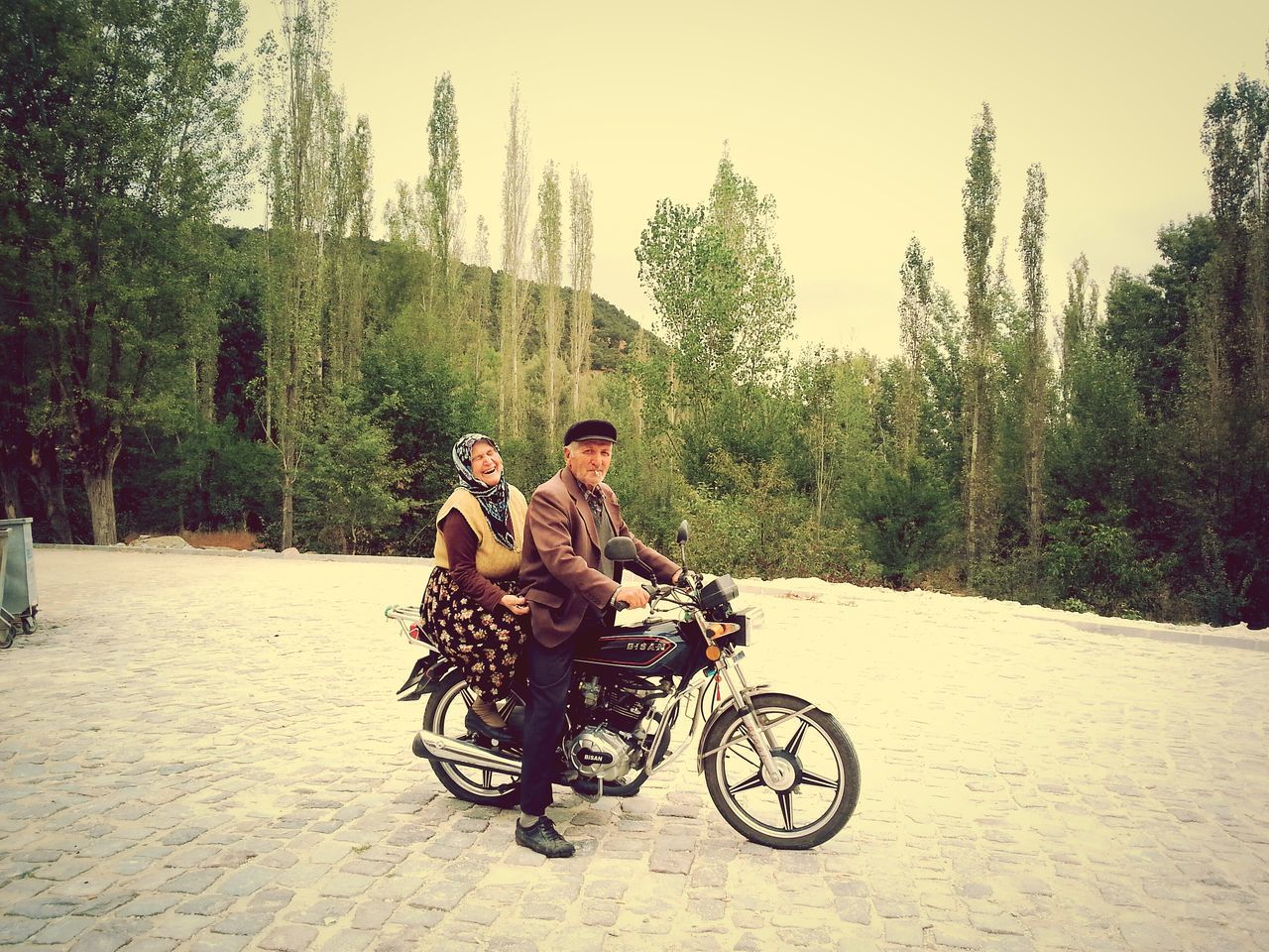 WOMAN RIDING BICYCLE ON ROAD