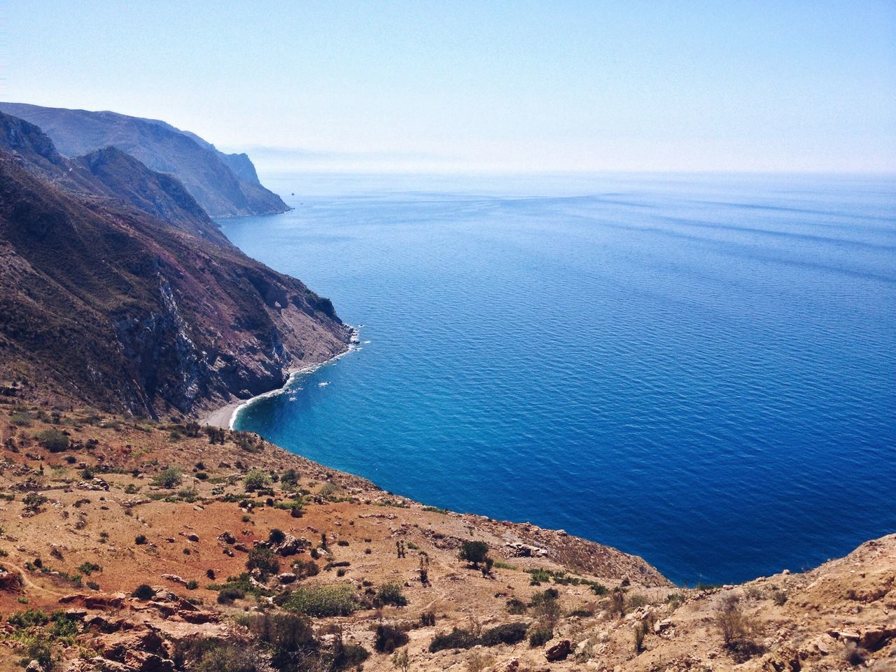 sea, horizon over water, water, tranquil scene, scenics, tranquility, beauty in nature, blue, nature, mountain, clear sky, coastline, idyllic, beach, shore, cliff, sky, seascape, copy space, rock formation