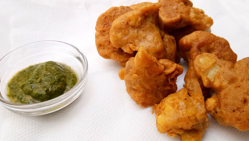 Vegetable pakora,cauliflower pakora,served hot indian snack,served along with green chilly sauce