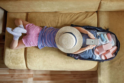 High angle view of woman lying down on floor at home